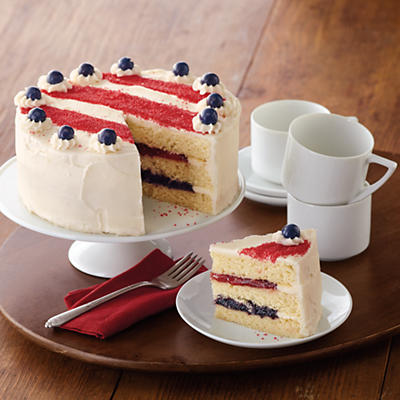 The Flag Cake is a delectable specialty cake, expertly crafted in our bakery in the heart of Southern Oregon. This all-American summer cake has three layers of fluffy vanilla cake separated by lusciou